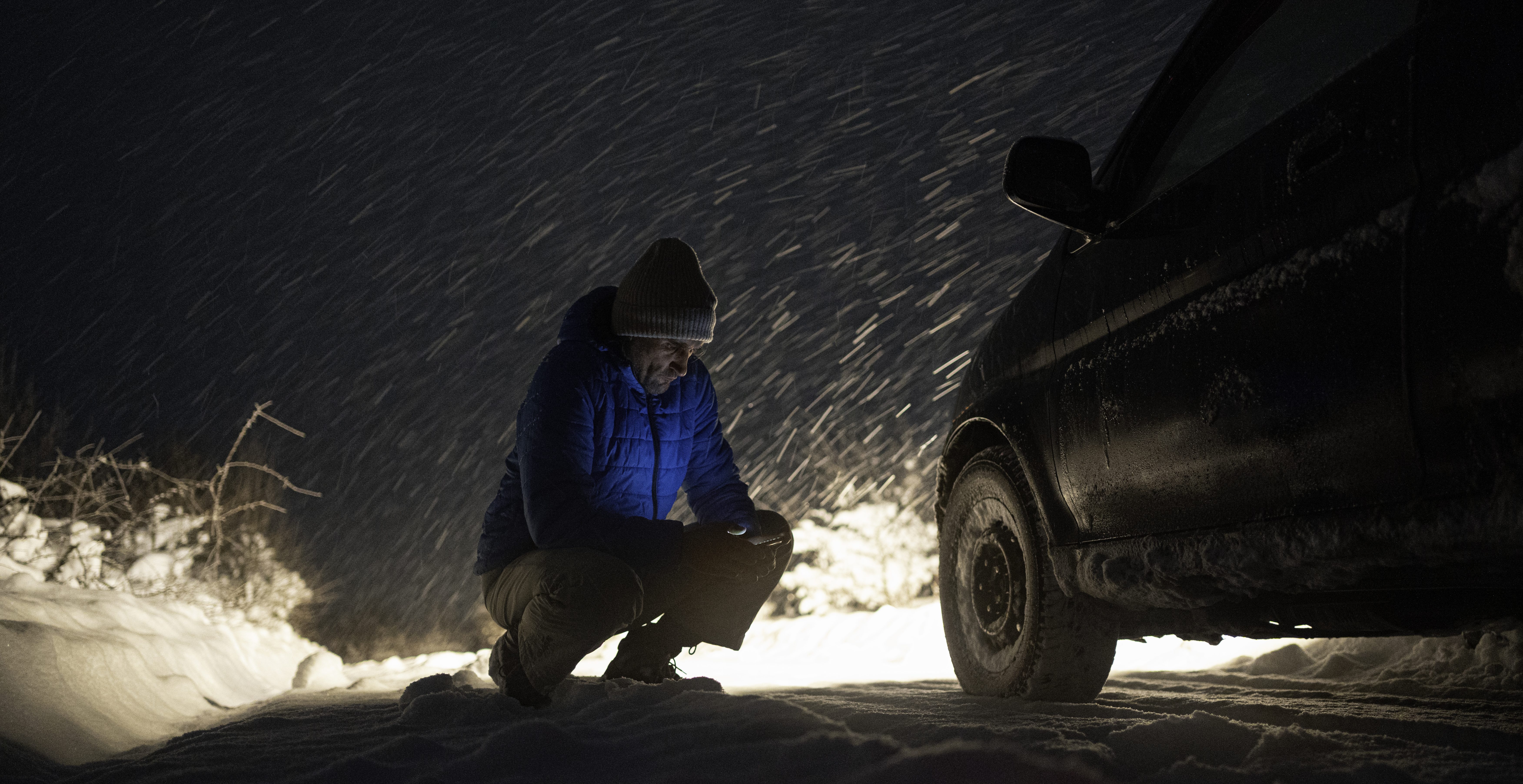 Car insurance. Winter car breakdown on the road late at night.