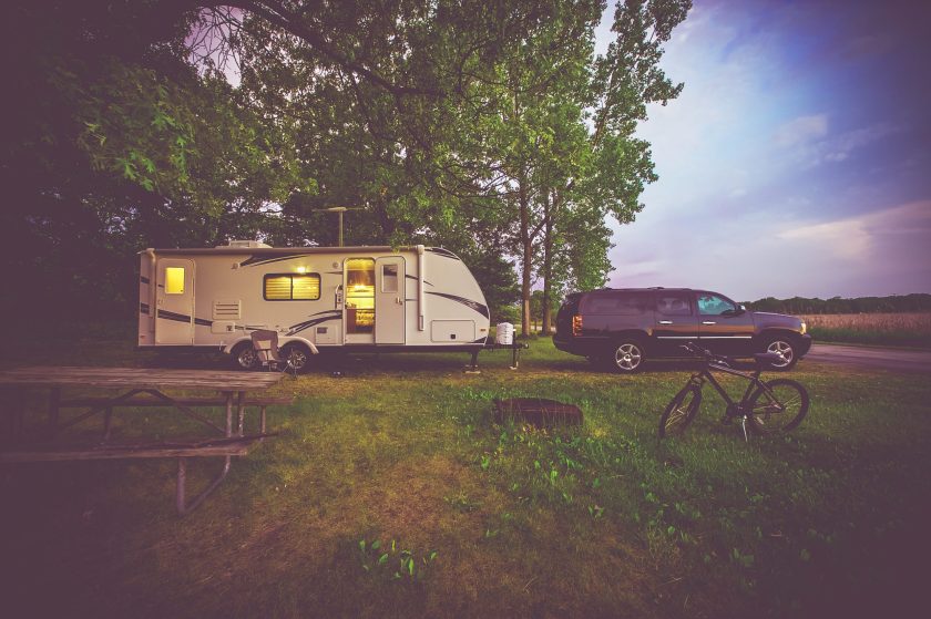 RV Camping Adventure. SUV Pulling Travel Trailer. Camper Journey.