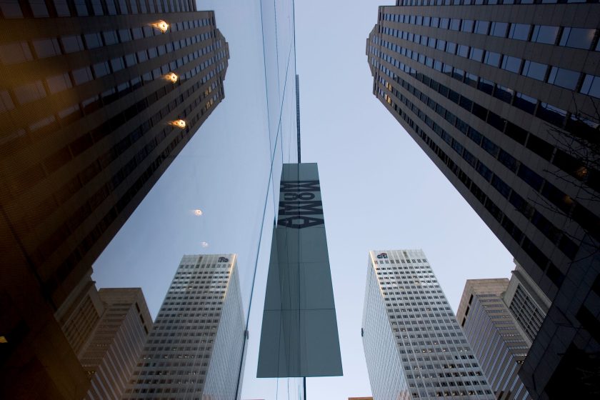 The glass facade of the newly expanded and renovated Museum of Modern Art, reflects the surrounding buildings. The new MoMA, designed by architect Yoshio Tanigchi