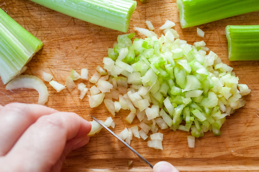 person chopping celery