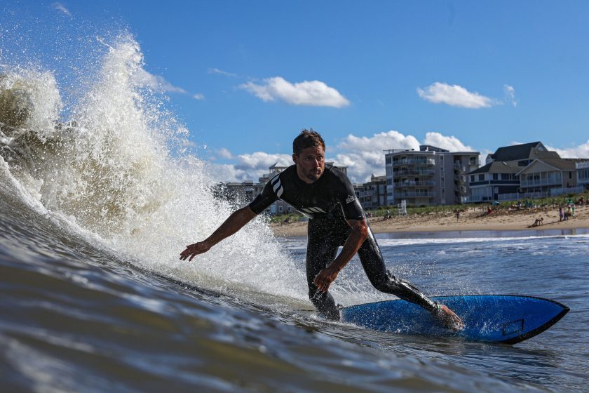 A surfer rides a wave after Tropical Storm Fay passes along the Maryland Eastern shore on July 10, 2020 in Ocean City, Maryland