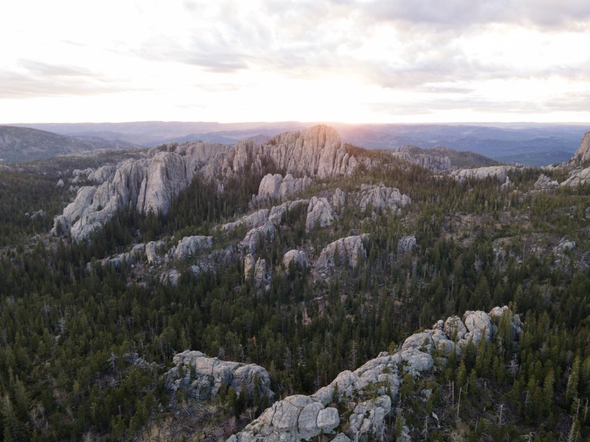 Drone view of granite peaks in the Black Hills National Forest of South Dakota at sunset.