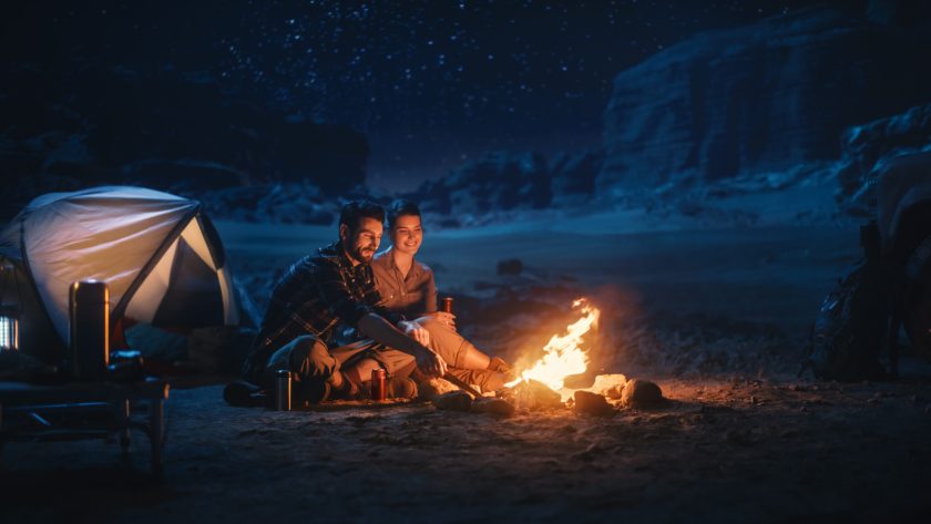 Happy Couple Nature Camping in the Canyon, Sitting Watching Campfire Together, Talking, Watching Night Sky