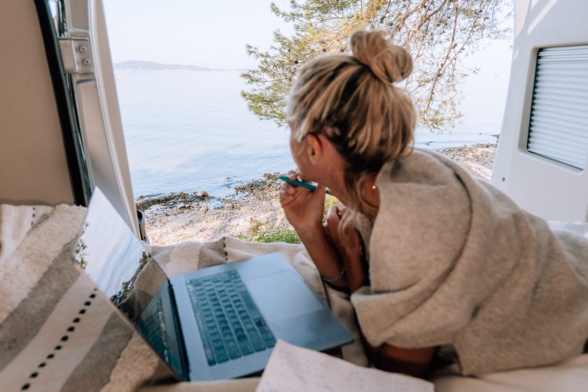 Woman working online from her Campervan