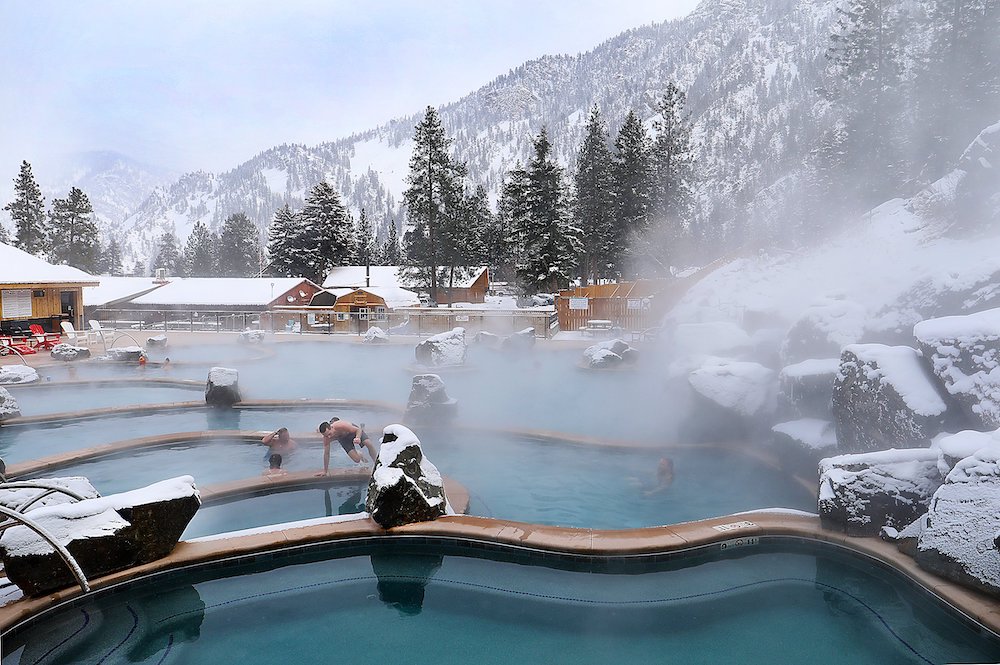 hot springs with snowy mountain in background