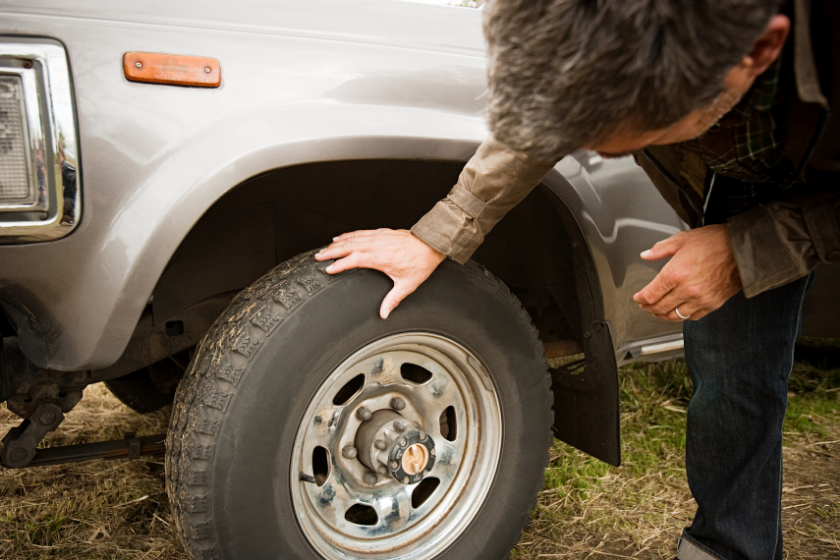 Man checking car tire