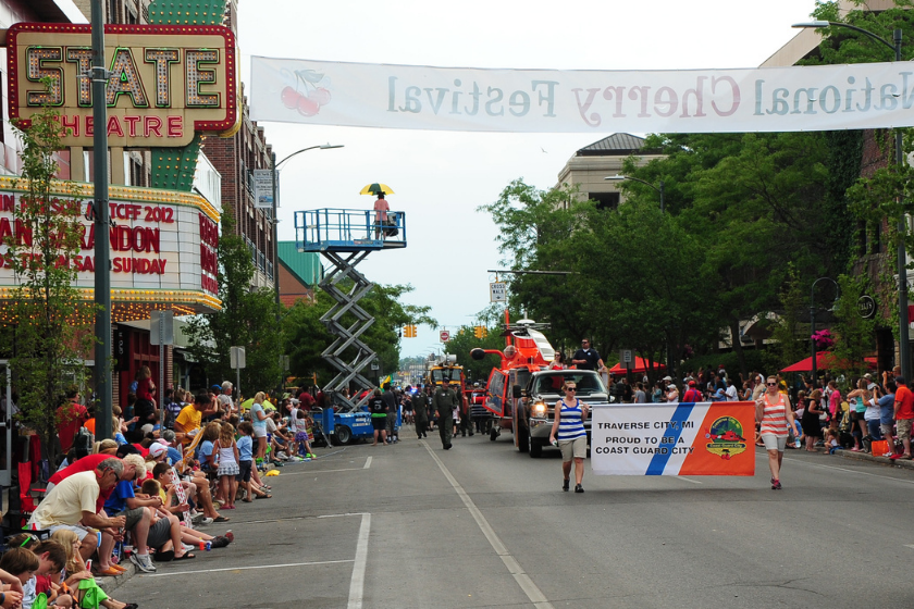 Crewmmembers of Coast Guard Air Station Traverse City ride and walk the 2012 National Cherry Festival Parade route, July 14, 2012.