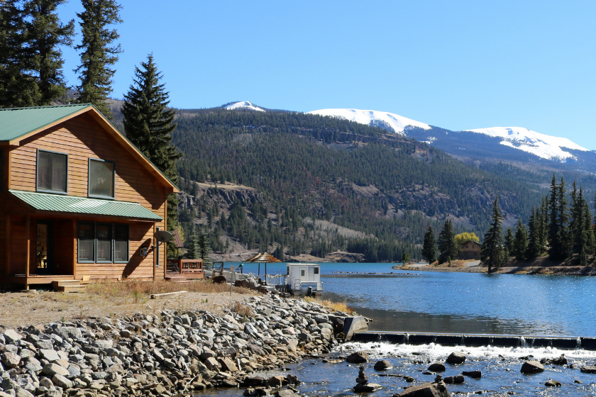 The outflow of Lake San Cristobal in Hinsdale County, Colorado. A cabin rests on the shoreline.