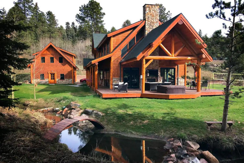 an estate on the lake, green forest in background