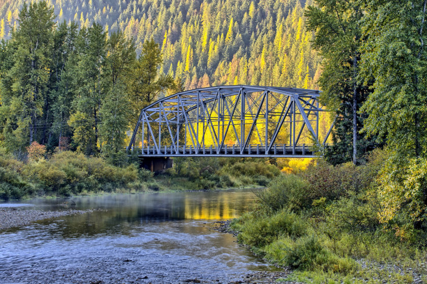 A small automobile bridge spans over a small section of the Coeur d'Alene river in north Idaho.