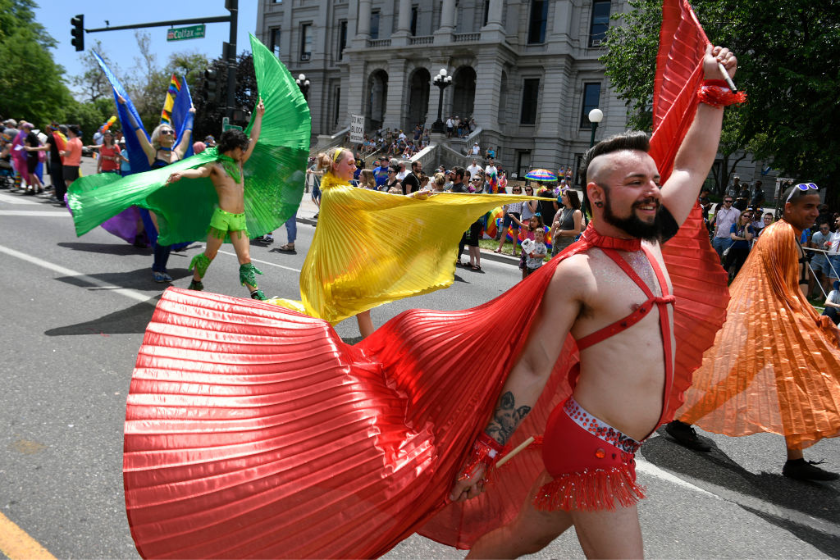 Matt Egan, right, takes part in the Denver Pride Parade on June 16, 2019 in Denver, Colorado.