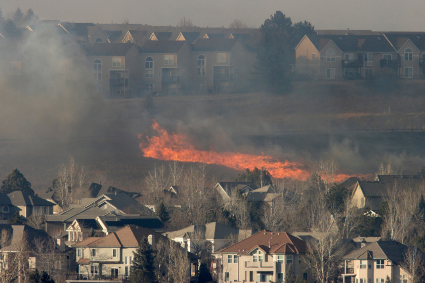 a line of a wildfire approaches homes in boulder, colorado