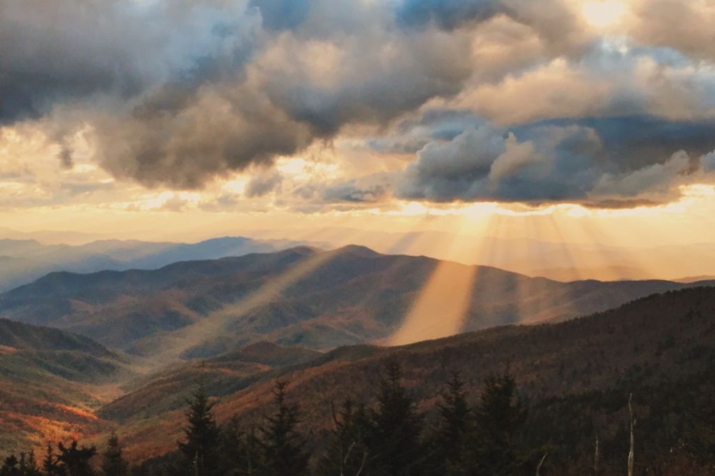 Sunlight bursts through the autumn clouds as sunbeams along Clingman's Dome in The Great Smoky Mountains National Park in Tennessee, USA