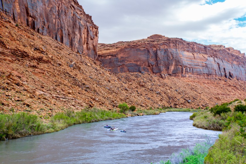 A scenic view of the Utah Landscape along the Highway 128 Scenic Byway near Moab. Rafts are visible on the river.