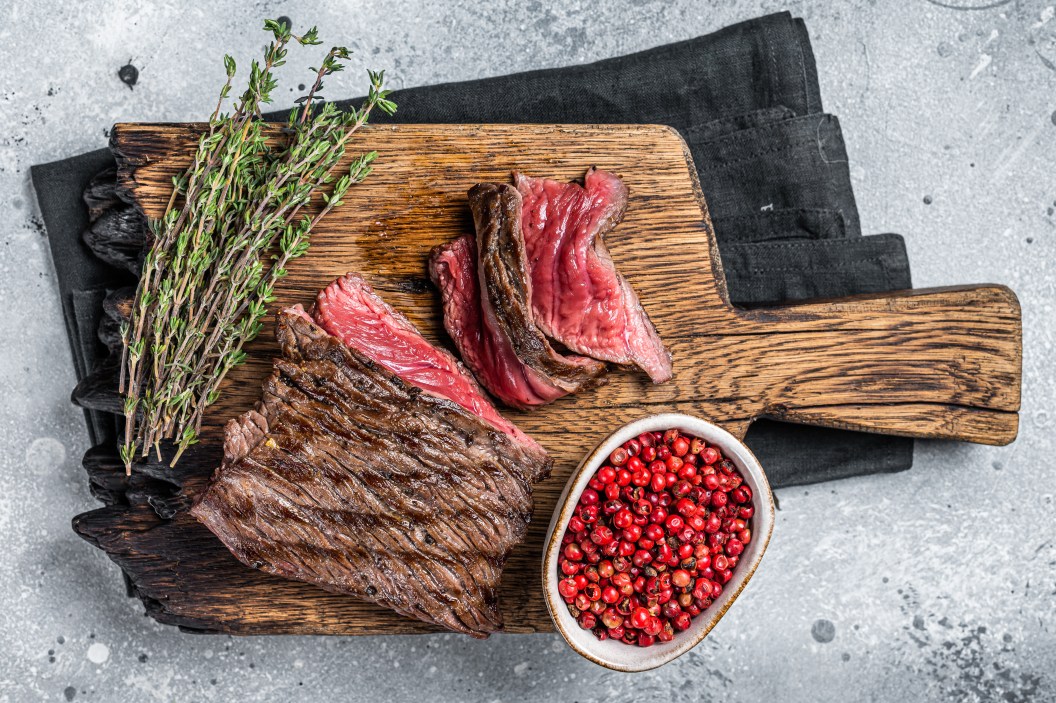 BBQ Grilled Wild Venison steak on wooden board. Gray background. Top view.