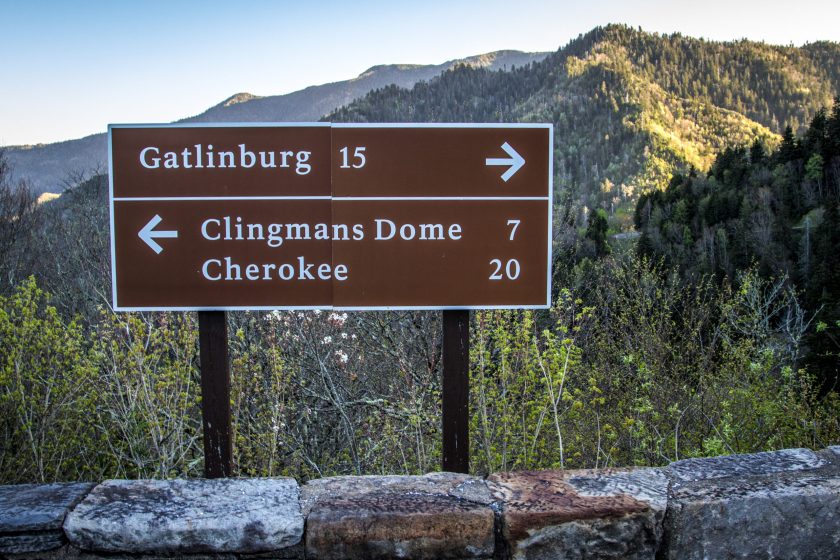 Directional road sign and mile marker to Gatlinburg, Tennessee and Cherokee, North Carolina on the Newfound Gap Road in the Great Smoky Mountains National Park.