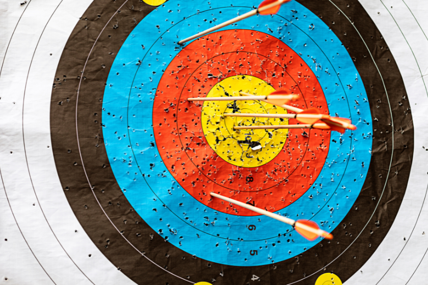 A large archery target with arrows in it