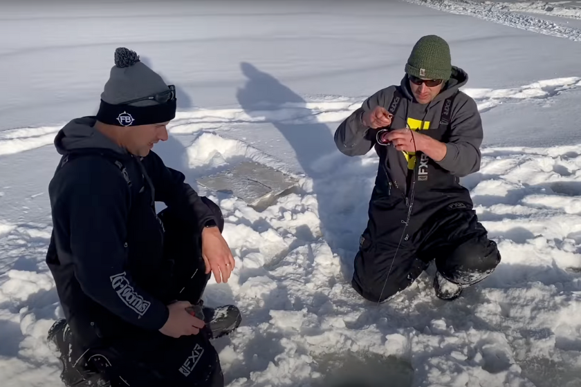 two men ice fishing