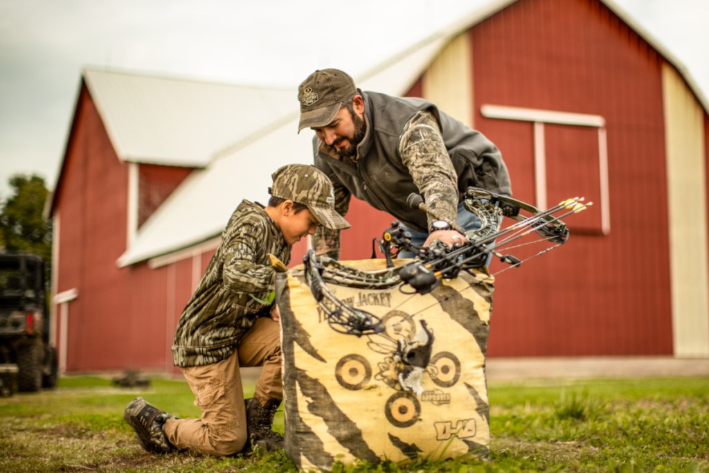 Two hunters checking their target while prepping for bowhunting.