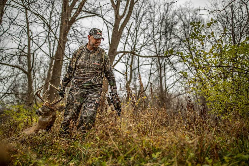 Solo hunter drags a deer out of the woods