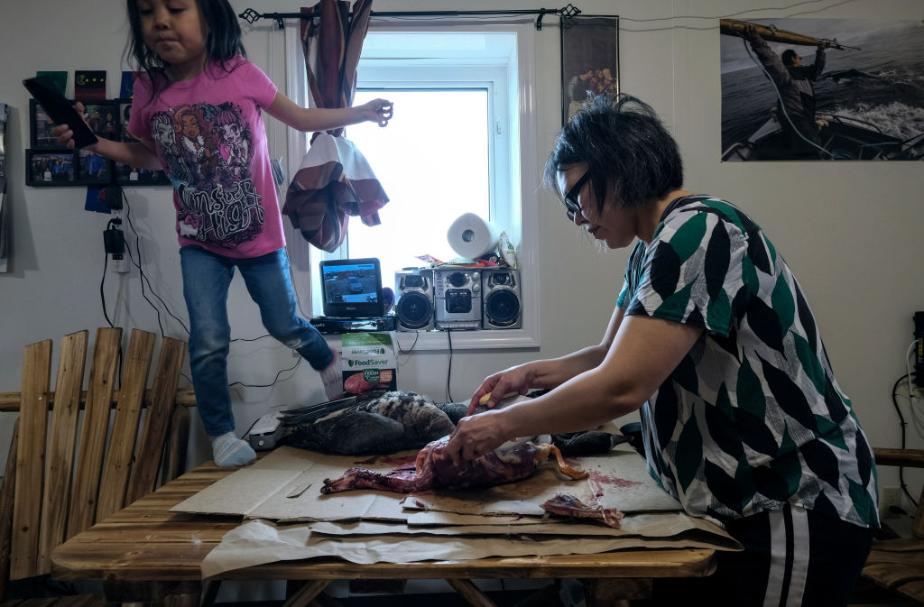Eunice Brower cleans waterfowl in the company of her daughter Charity in Nuiqsut, AK on May 29, 2019. Members of the remote village rely on hunting and fishing for subsistence.