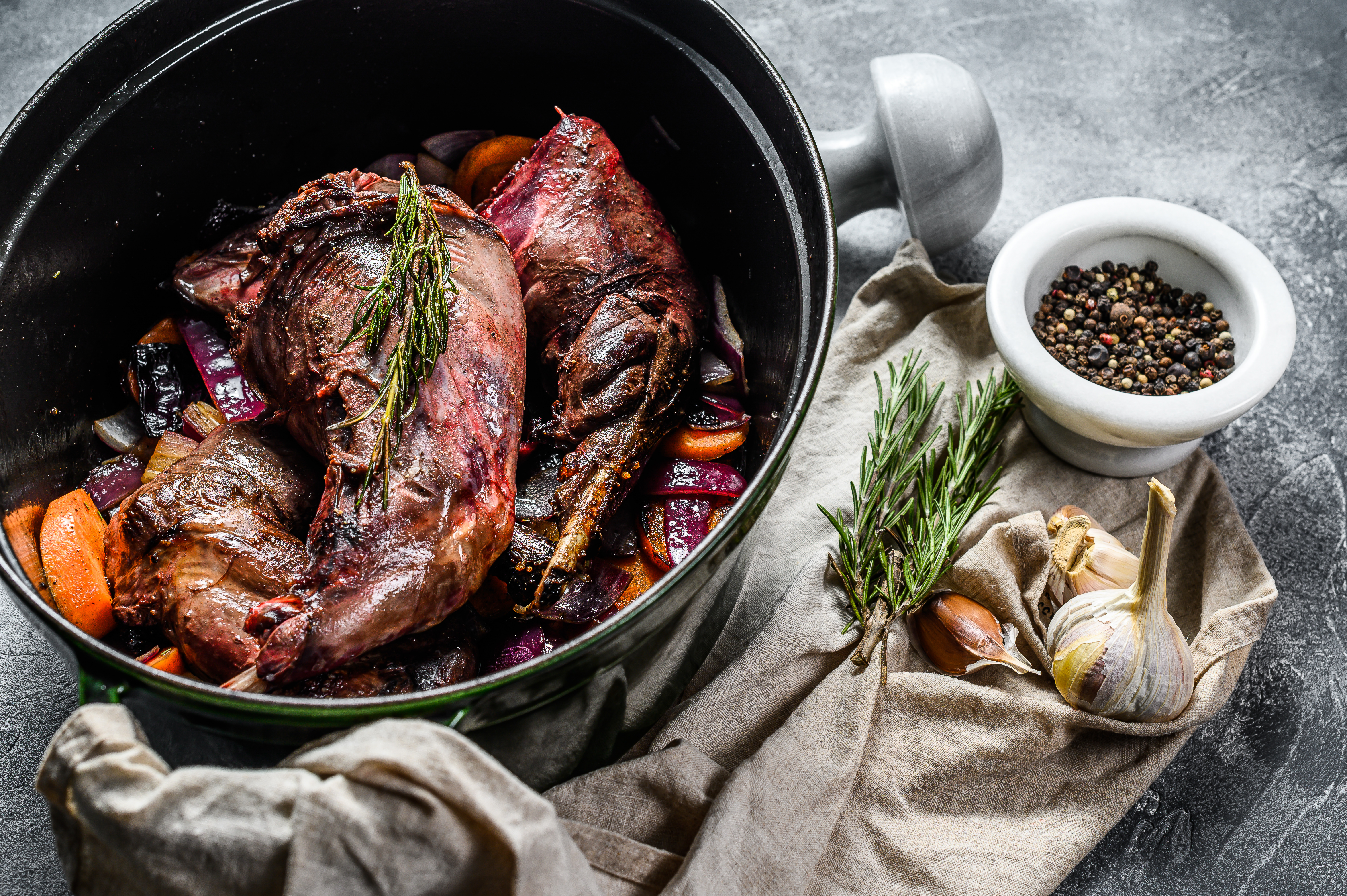 Wild hare with Vegetable in White Wine Sauce, Stewpot. Organic meat. Cooking stew. Top view.