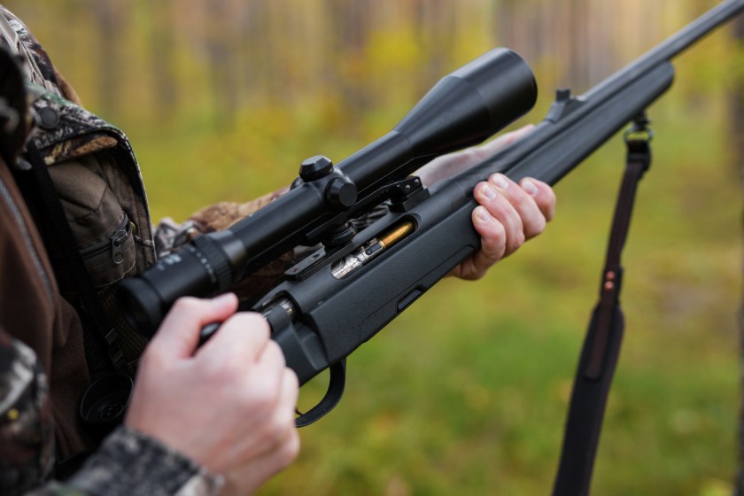 Closeup on a hunting rifle with a scope.