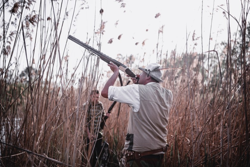 Group of Hunters Hidden in the Swamp and Preparing for Hunting