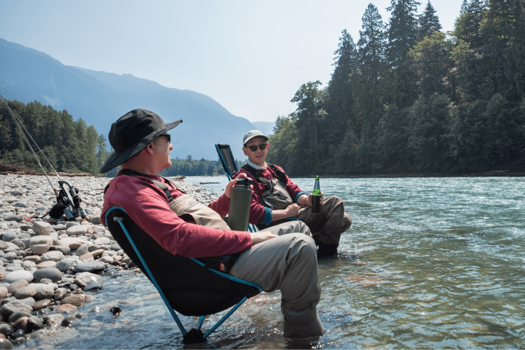 friends sharing fun fishing facts near a river