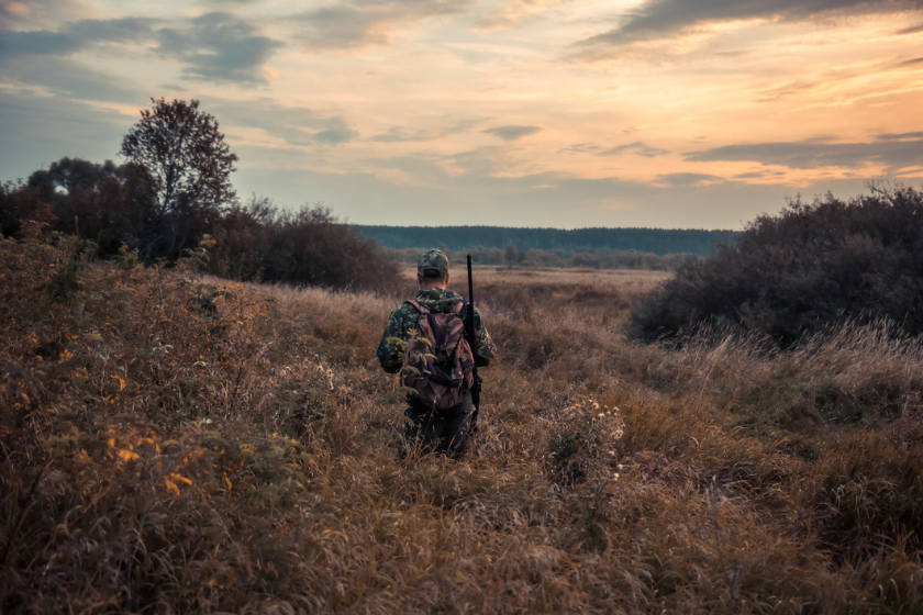 man walking into sunset