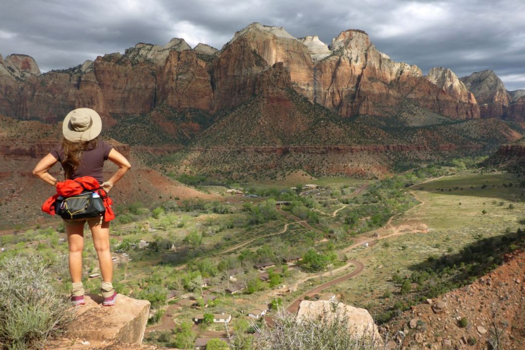 Woman hikes Zion National Park desert Watchman Trail Utah enjoy view rock formations