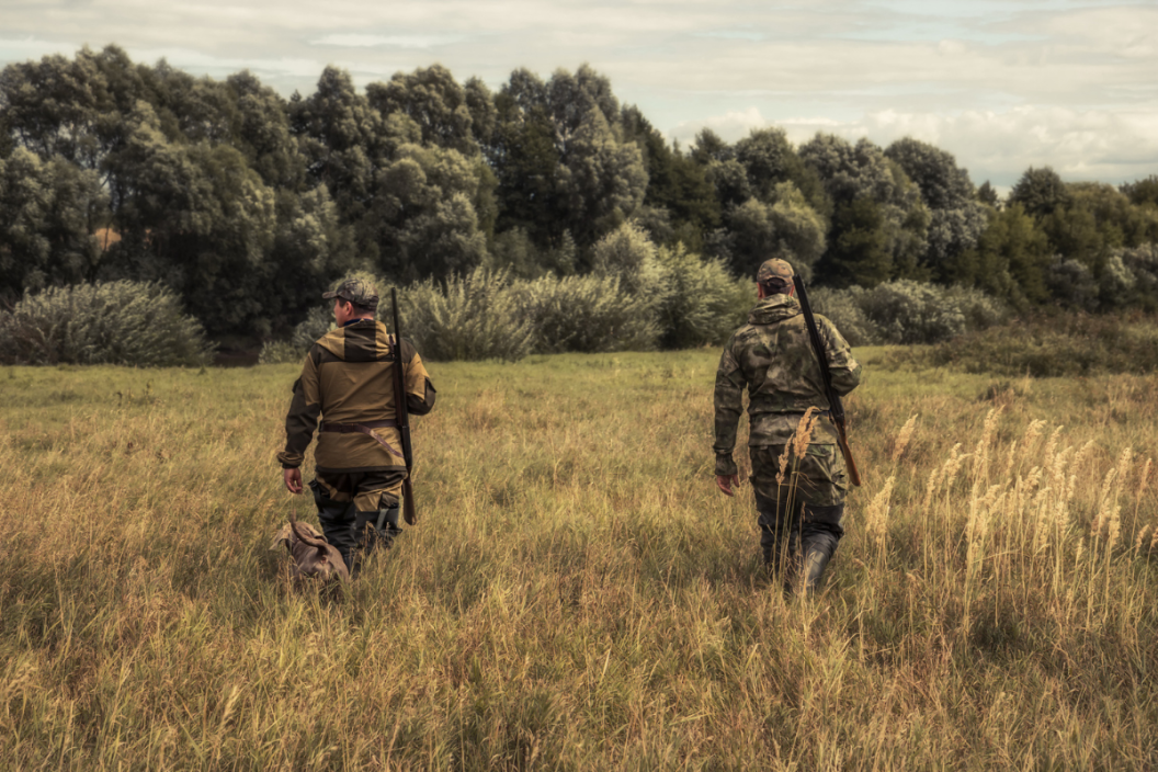 two hunters walking