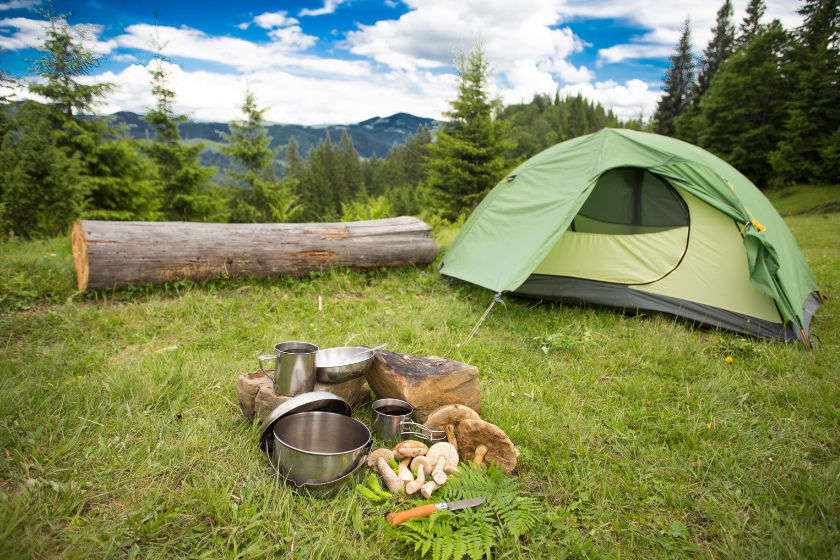 tent by a fire with pots