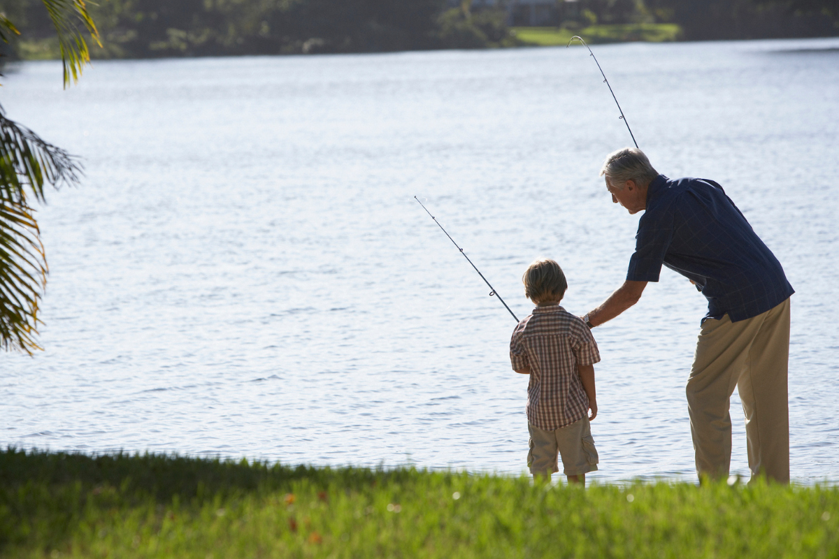 a boy fishes with his father