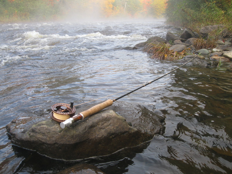 Fly Fishing rod on a rock in the river