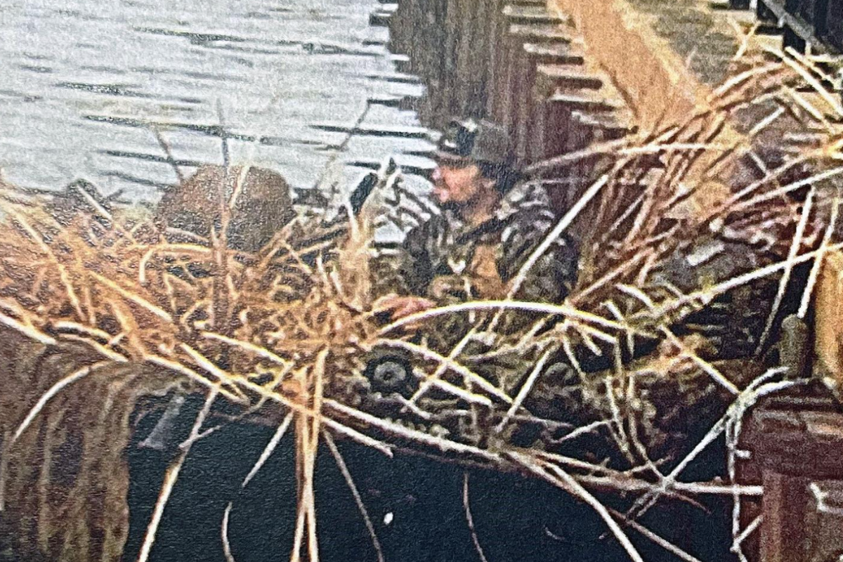 Duck hunter on the river