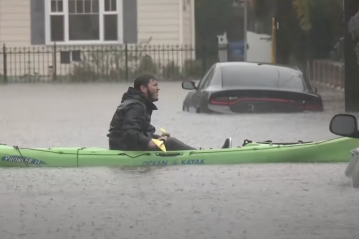 man kayaks down street in Santa Barbara