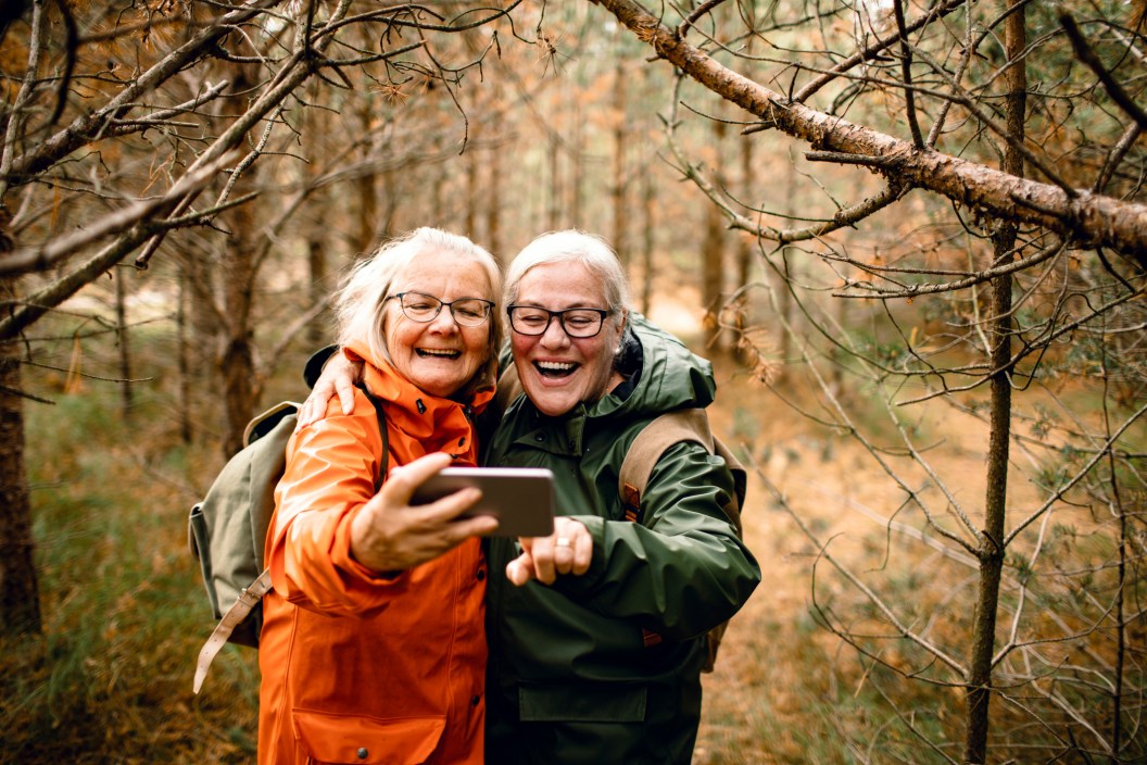 two mature women taking selfie together on a hike