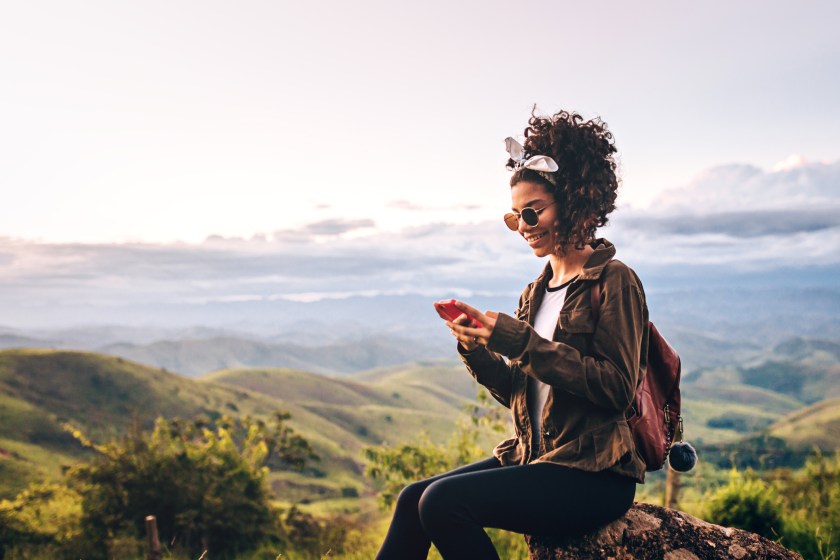 girl looking at her phone on a hike