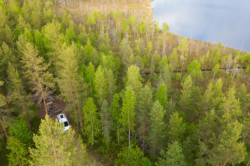 Camping car wildcamping in a forest in Sweden with a lake nearby
