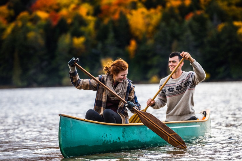 Couple enjoying a ride on a typical canoe in the Algonquin Park, Ontario, Canada.