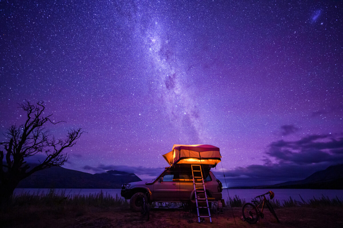 Starry night with backdrop of southern alps of New Zealand and beautiful Lake Ohau in South Island, New Zealand.