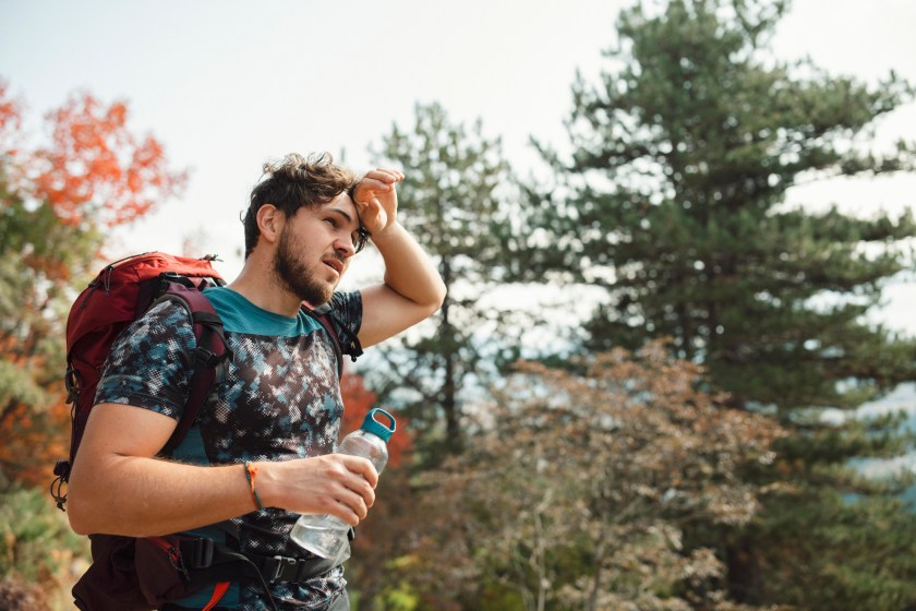 Man tired from hiking taking a break