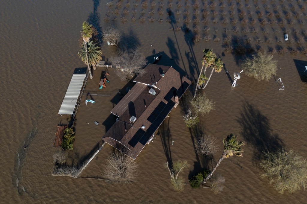 CORCORAN, CA - MARCH 24: In an aerial view, a home on an almond farm is flooded as a series of atmospheric river storms melts record amounts of snow in the Sierra Nevada Mountains on March 24, 2023 near Corcoran, California. The once-massive Tule Lake disappeared as faming diverted its waters and developed on the rich soils of the lakebed. As levees become unable to hold back the floods, speculation is rising that the lake will be reborn. 