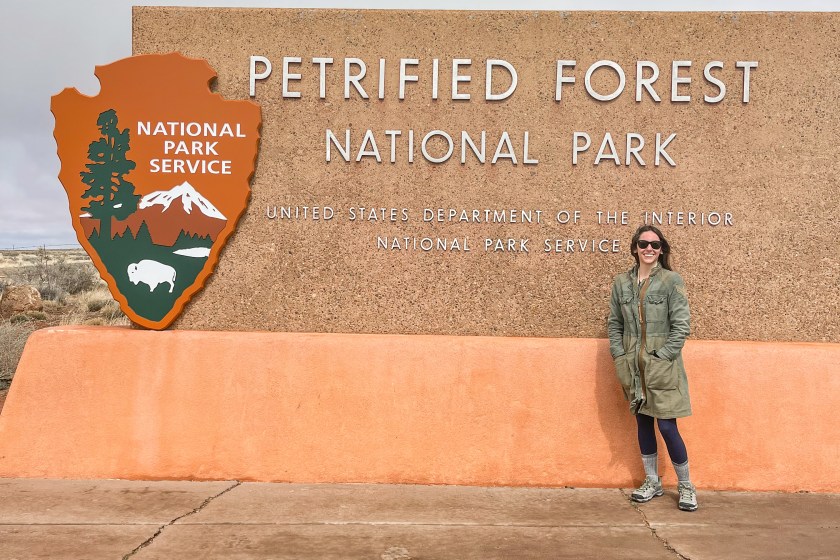 Kendra in front of Petrified Forest sign