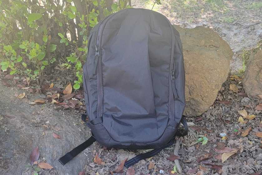 Black Max Backpack sitting up against a rock