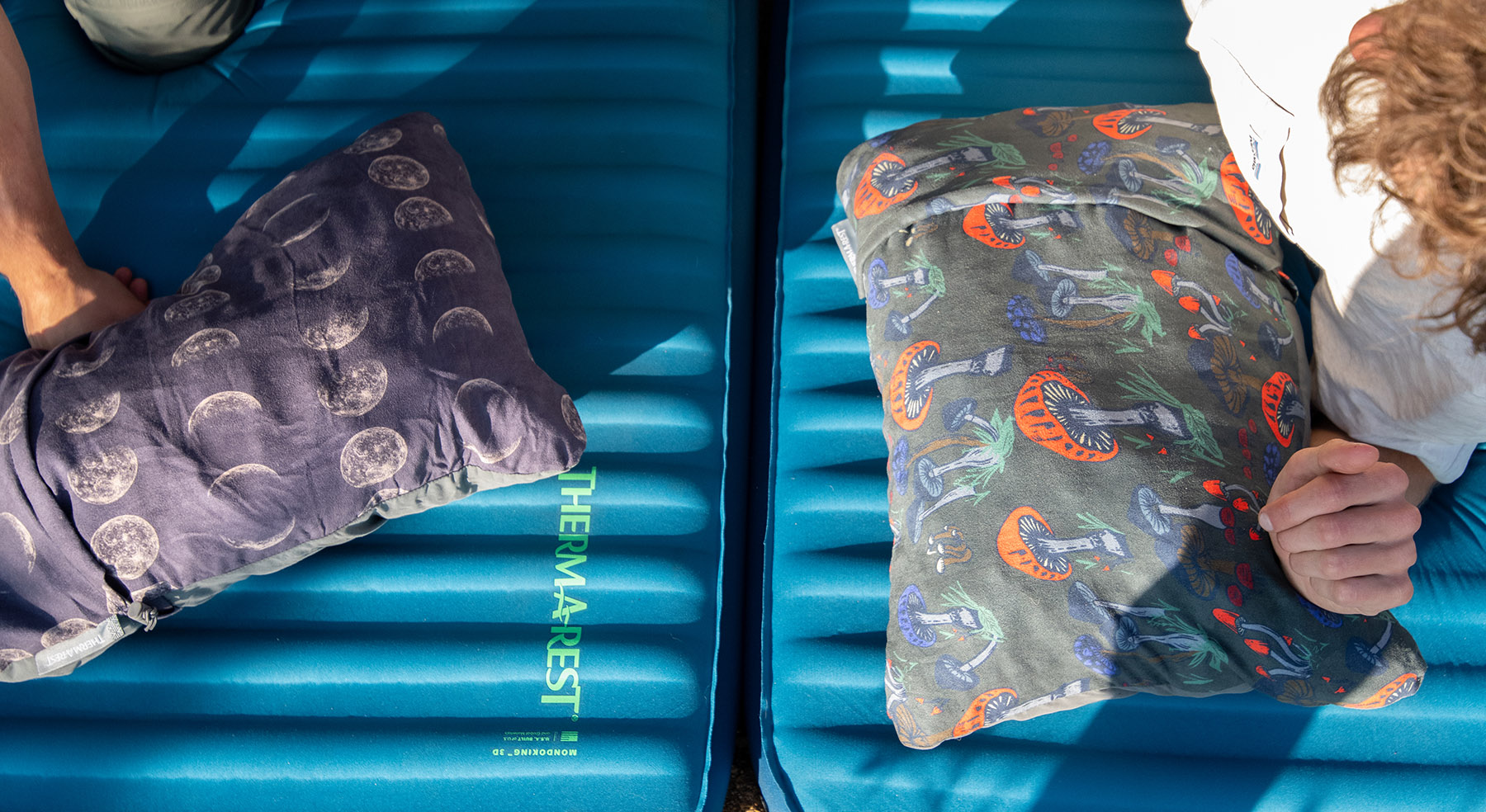 Two printed camping pillows from Thermarest on top of camping mattresses