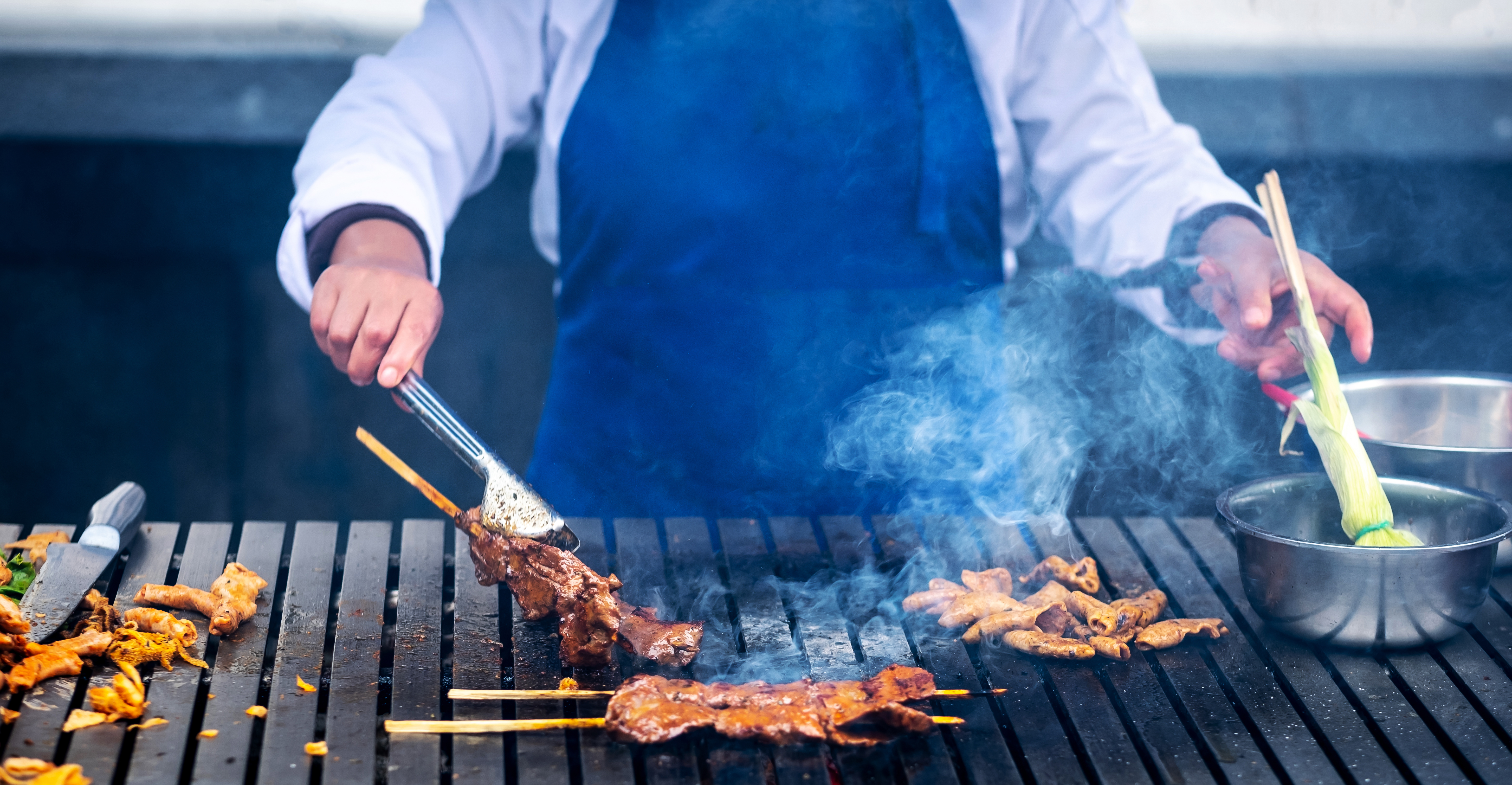 Chef cooking meat on the street