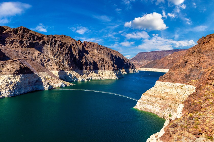 View from Hoover Dam at Nevada and Arizona border of the Colorado river with a low water level strip on cliff at Lake Mead.