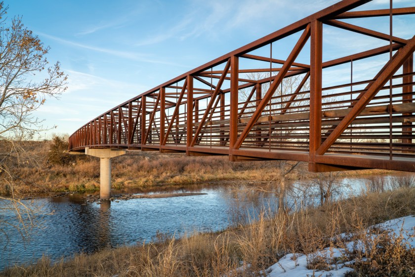 Bike trail and a footbridge over the South Platte River Trail near Brighton, Colorado.
